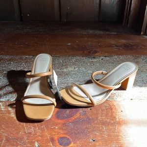 Brown square heel strap heels.